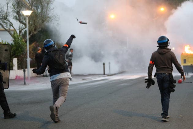 October 5, 2026, Anglet, Nouvelle Aquitaine, France: A plainclothes police officer from the anti-crime brigade (BAC) throws a tear gas canister towards youths during a protest by high school students against the government outside the Cantau high school in Anglet, southwestern France, on October 5, 2026. Students have been blocking schools across France since September 21 to demand more teachers, smaller classes and better school buildings. Cantau was closed by authorities after clashes in recent days. Anglet France - ZUMAb298 20261005_zsp_b298_006 Copyright: xJulesxBuonx