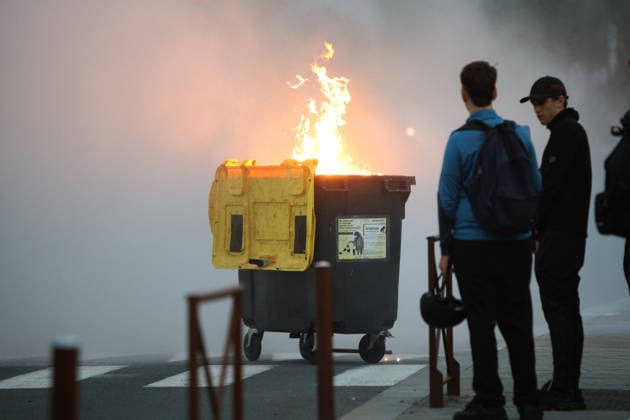 October 5, 2026, Anglet, Nouvelle Aquitaine, France: Youths look on as a waste container burns during a protest by high school students against the government outside the Cantau high school in Anglet, southwestern France, on October 5, 2026. Students have been blocking schools across France since September 21 to demand more teachers, smaller classes and better school buildings. Cantau was closed by authorities after clashes in recent days. Anglet France - ZUMAb298 20261005_zsp_b298_009 Copyright: xJulesxBuonx