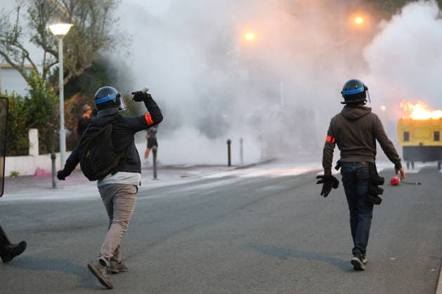 October 5, 2026, Anglet, Nouvelle Aquitaine, France: A plainclothes police officer from the anti-crime brigade (BAC) throws a tear gas canister towards youths during a protest by high school students against the government outside the Cantau high school in Anglet, southwestern France, on October 5, 2026. Students have been blocking schools across France since September 21 to demand more teachers, smaller classes and better school buildings. Cantau was closed by authorities after clashes in recent days. Anglet France - ZUMAb298 20261005_zsp_b298_011 Copyright: xJulesxBuonx
