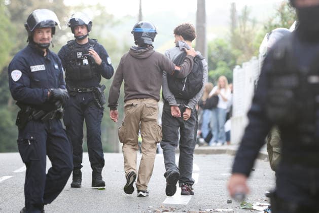 October 5, 2026, Anglet, Nouvelle Aquitaine, France: Police officers from the anti-crime brigade (BAC) detain a handcuffed youth who had been hiding in bushes during a protest by high school students against the government outside the Cantau high school in Anglet, southwestern France, on October 5, 2026. Students have been blocking schools across France since September 21 to demand more teachers, smaller classes and better school buildings. Cantau was closed by authorities after clashes in recent days. Anglet France - ZUMAb298 20261005_zsp_b298_016 Copyright: xJulesxBuonx