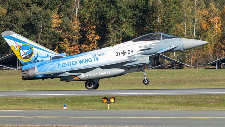 Eurofighter at Nuremberg Airport: German Air Force Practices Dispersed Operations, Nuremberg, October 5, 2026 A German Air Force Eurofighter Typhoon with the tail number 31 09 is preparing to land at the airport. The aircraft features a special paint scheme commemorating the 65th anniversary of Fighter Wing 74 and the 70th anniversary of 20261005-1V9A1046-M4000