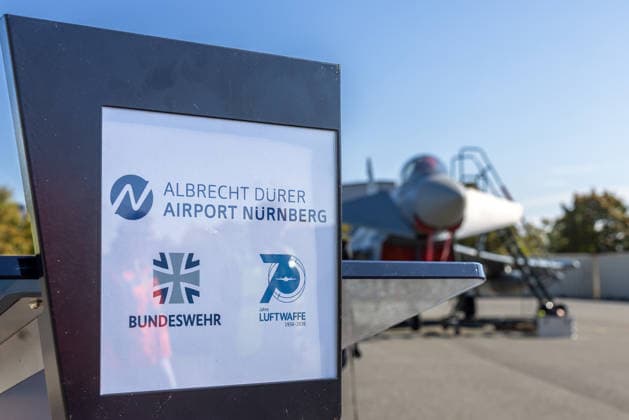 Eurofighter at Nuremberg Airport: German Air Force Practices Dispersed Operations, Nuremberg, October 5, 2026 A German Air Force Eurofighter stands on the tarmac at the airport; in the foreground is a sign reading Albrecht Dürer Airport Nuremberg, German Armed Forces and 70 Years of the German Air Force The German Ai 20261005-286A0298-M4000