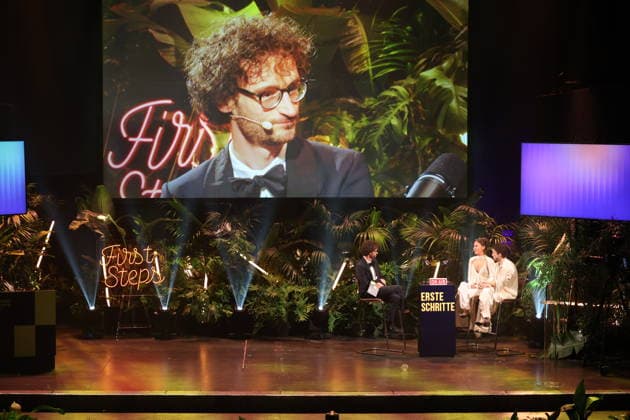 FIRST STEPS 2026: Hosts Malaya and Maximilian; Laudatory Remarks by Karl Schirnhofer; Award Ceremony on Stage at the FIRST STEPS 2026 Awards Ceremony at the Theater des Westens in Berlin Copyright: xEventpressxFuhrx