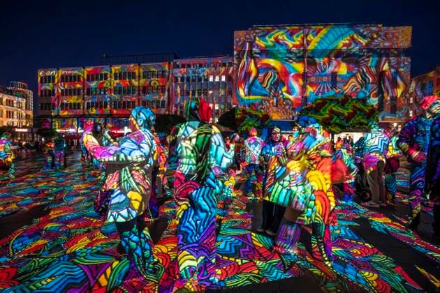 Essen Light Festival, in the city center; the light installation Diving in the Sea of Colors by Berlin-based artist Daniel Margraf illuminates the buildings on the large Kennedy Platz; visitors become part of the light art installation; North Rhine-Westphalia, Germany; Essen Light Festival