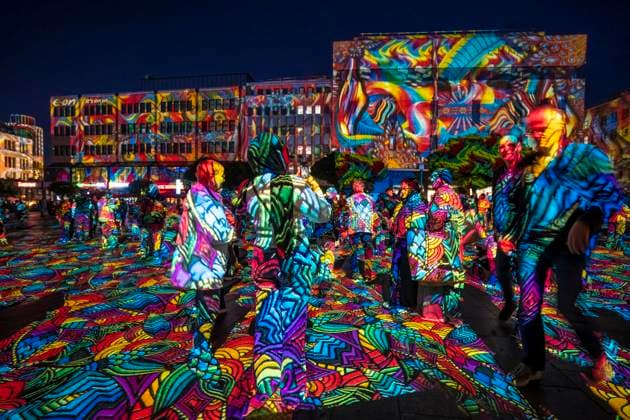 Essen Light Festival, in the city center; the light installation Diving in the Sea of Colors by Berlin-based artist Daniel Margraf illuminates the buildings on the large Kennedy Platz; visitors become part of the light art installation; North Rhine-Westphalia, Germany; Essen Light Festival