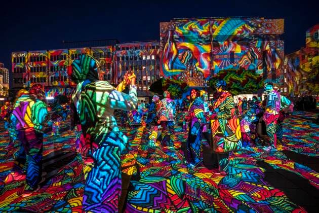 Essen Light Festival, in the city center; the light installation Diving in the Sea of Colors by Berlin-based artist Daniel Margraf illuminates the buildings on the large Kennedy Platz; visitors become part of the light art installation; North Rhine-Westphalia, Germany; Essen Light Festival