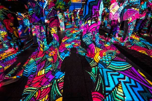 Essen Light Festival, in the city center; the light installation Diving in the Sea of Colors by Berlin-based artist Daniel Margraf illuminates the buildings on the large Kennedy Platz; visitors become part of the light art installation; North Rhine-Westphalia, Germany; Essen Light Festival