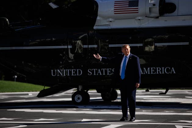 President Donald Trump turns to reporters to gesture at the White House Ballroom construction before boarding Marine One at the White House in Washington, DC on Monday, October 5, 2026. Trump is heading to Grand Island, Nebraska where he will speak at a rally for Republican Senator Pete Ricketts.  WASP20261005112 SamuelxCorum