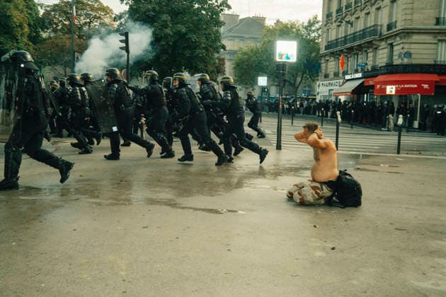 Paris Students Protest Education Conditions A shirtless demonstrator sits on the pavement as riot police advance across the street in Paris, France, on October 6, 2026. France s Interior Ministry said 256,000 people marched nationwide, including 56,000 in Paris, during the student-led day of action over school conditions. High school students called for more education funding and staff, smaller classes and improved facilities, with teachers, parents and unions joining demonstrations. Paris Ile de France France Copyright: xDavoodxMaeilix