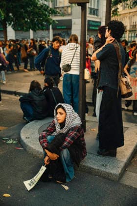 Paris Students Protest Education Conditions A demonstrator wearing a patterned scarf sits on a curb as a crowd gathers behind her in Paris, France, on October 6, 2026. France s Interior Ministry said 256,000 people marched nationwide, including 56,000 in Paris, during the student-led day of action over school conditions. High school students called for more education funding and staff, smaller classes and improved facilities, with teachers, parents and unions joining demonstrations. Paris Ile de France France Copyright: xDavoodxMaeilix