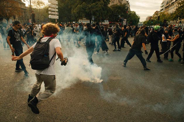 Paris Students Protest Education Conditions A demonstrator runs past a smoking tear gas canister as people scatter in the street in Paris, France, on October 6, 2026. France s Interior Ministry said 256,000 people marched nationwide, including 56,000 in Paris, during the student-led day of action over school conditions. High school students called for more education funding and staff, smaller classes and improved facilities, with teachers, parents and unions joining demonstrations. Paris Ile de France France Copyright: xDavoodxMaeilix