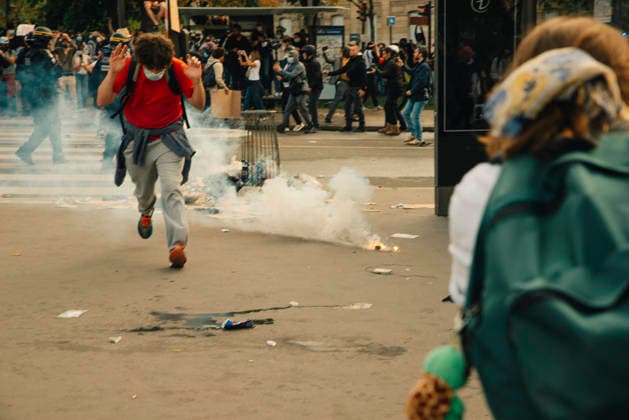 Paris Students Protest Education Conditions A demonstrator runs past a smoking tear gas canister in an open square in Paris, France, on October 6, 2026. France s Interior Ministry said 256,000 people marched nationwide, including 56,000 in Paris, during the student-led day of action over school conditions. High school students called for more education funding and staff, smaller classes and improved facilities, with teachers, parents and unions joining demonstrations. Paris Ile de France France Copyright: xDavoodxMaeilix