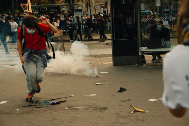 Paris Students Protest Education Conditions A demonstrator in a red top runs past a smoking tear gas canister in Paris, France, on October 6, 2026. France s Interior Ministry said 256,000 people marched nationwide, including 56,000 in Paris, during the student-led day of action over school conditions. High school students called for more education funding and staff, smaller classes and improved facilities, with teachers, parents and unions joining demonstrations. Paris Ile de France France Copyright: xDavoodxMaeilix