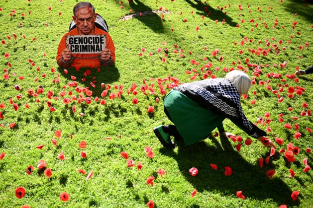PRO-PALESTINE VIGIL, Pro-Palestine protestors place poppies on the lawn around a placard featuring Israel Prime Minister Benjamin Netanyahu during a vigil for Gaza at the State Library Victoria in Melbourne, Wednesday, October 7, 2026. ( NO ARCHIVING MELBOURNE VICTORIA Australia  Copyright: xJOELxCARRETTx 20261007130537187370