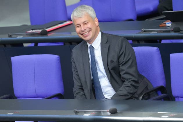 German Bundestag, 98th Plenary Session: A Portrait of Steffen Bilger, Federal Minister of Transportation. The minister smiles joyfully from the government bench during the 98th session of the German Bundestag in Berlin, October 7, 2026. Berlin, Berlin, Germany