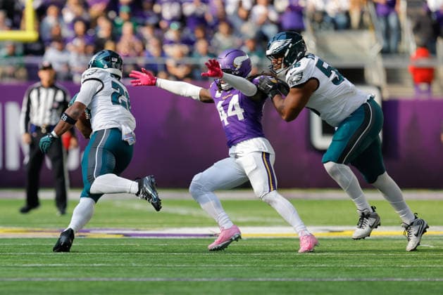 MINNEAPOLIS, MN - OCTOBER 19: Minnesota Vikings safety Josh Metellus (44) attempts to tackle Philadelphia Eagles running back Saquon Barkley (26) while being held by offensive tackle Tyler Steen (56) during the second half of the NFL, American Football Herren, USA game between the Minnesota Vikings and Philadelphia Eagles on October 19th, 2025, at U.S. Bank Stadium in Minneapolis, MN. (Photo by Bailey Hillesheim Icon Sportswire) NFL: OCT 19 Eagles at Vikings EDITORIAL USE ONLY Icon251019037