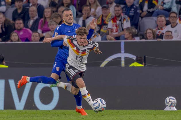 Munich, Germany October 1, 2026 UEFA Nations League 2026–2027 League Phase Group A2 Match 3 Germany vs. Serbia Pictured from left: Filip Kostic (SRB) and Philipp Treu (GER) in a tackle. DFB and DFL regulations prohibit any use of photographs as image sequences and or quasi-video. Allianz Arena Bayern Copyright: xFotostandx xSchäferx