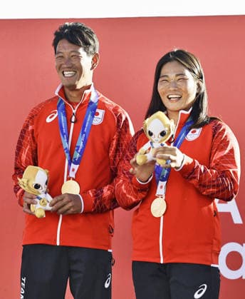 Aichi-Nagoya Asian Games: Sailing Japanese sailors Yurie Seki (R) and Tetsuya Isozaki pose after winning the Aichi-Nagoya Asian Games mixed dinghy gold at Kaiyoh Yacht Harbor in Gamagori in Aichi Prefecture, central Japan, on Oct. 2, 2026.  A14AA0005629737P