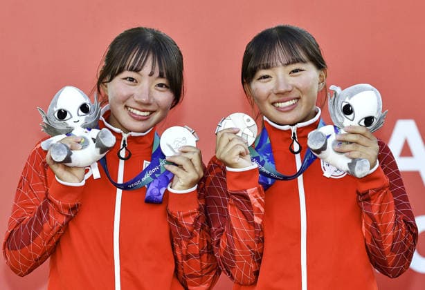 Aichi-Nagoya Asian Games: Sailing Japanese sailors Natsumi Funazawa (R) and Natsuko Funazawa pose after winning the Aichi-Nagoya Asian Games girls skiff silver at Kaiyoh Yacht Harbor in Gamagori in Aichi Prefecture, central Japan, on Oct. 2, 2026.  A14AA0005629826P