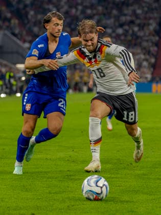 Munich, Germany October 1, 2026 UEFA Nations League 2026–2027 League Phase Group A2 Match 3 Germany vs. Serbia Pictured from left: Lazar Samardzic (SRB) and Maximilian Mittelstädt (GER) in a tackle. DFB and DFL regulations prohibit any use of photographs as image sequences or or quasi-video. Allianz Arena, Bayern Copyright: xFotostandx xSchäferx