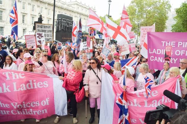 October 1, 2025, London, United Kingdom: Protesters from the group Pink Ladies hold pink Union Jacks, banners and placards in Whitehall opposite Downing Street during a demonstration against illegal immigration and against housing migrants in hotels. The group claims that its ongoing protests are about protecting women and children. London United Kingdom - ZUMAs197 20251001_aaa_s197_091 Copyright: xVukxValcicx