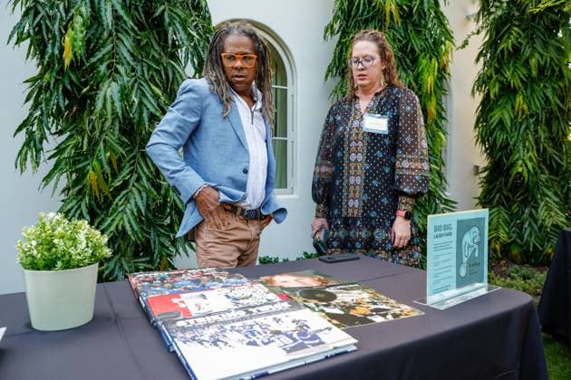 October 23, 2025, St. Petersburg, Florida, USA: Tampa Bay Times photojournalist Dirk Shadd and Traci Johnson, managing editor for sports, production and visuals, look over a table they just set up with books and magazines during the annual Cocktails and News fundraiser event on Thursday, Oct. 23, 2025, in St. Petersburg. St. Petersburg USA - ZUMAs70_ 20251023_zan_s70_056 Copyright: xJeffereexWoox
