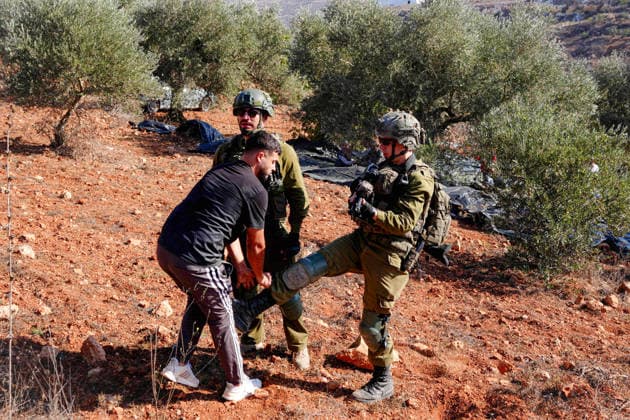 Israeli forces injure Palestinian farmer during raids on olive farms NABLUS, WEST BANK, PALESTINE - OCTOBER 2: Israeli military forces and settlers intervene against Palestinian farmers and international activists harvesting olives in the town of Beita, in Nablus, West Bank, Palestine on October 02, 2026. Israeli settlers beat the 46-year-old Palestinian man in the town of Beita, according to the Palestinian Red Crescent Society. Witnesses told Anadolu that a group of Israeli settlers fired stun grenades and tear gas at farmers in the Jabal al-Arma area, forcing them to leave. Issam Rimawi Anadolu Nablus West Bank. Editorial use only. Please get in touch for any other usage. Copyright: x2026xAnadoluxIssamxRimawix