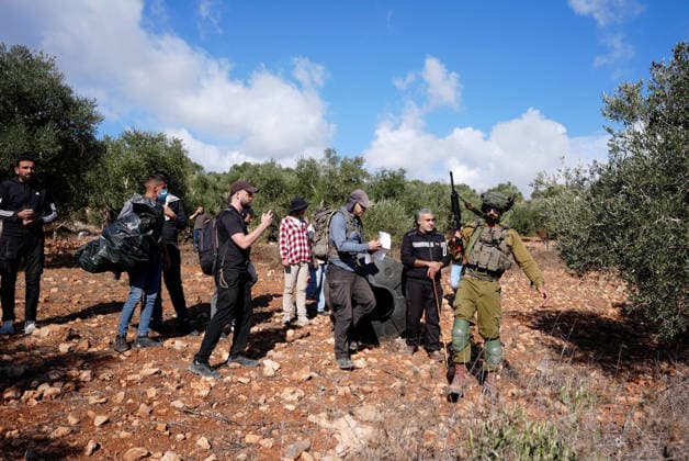 Israeli forces injure Palestinian farmer during raids on olive farms NABLUS, WEST BANK, PALESTINE - OCTOBER 2: Israeli military forces and settlers intervene against Palestinian farmers and international activists harvesting olives in the town of Beita, in Nablus, West Bank, Palestine on October 02, 2026. Israeli settlers beat the 46-year-old Palestinian man in the town of Beita, according to the Palestinian Red Crescent Society. Witnesses told Anadolu that a group of Israeli settlers fired stun grenades and tear gas at farmers in the Jabal al-Arma area, forcing them to leave. Issam Rimawi Anadolu Nablus West Bank. Editorial use only. Please get in touch for any other usage. Copyright: x2026xAnadoluxIssamxRimawix