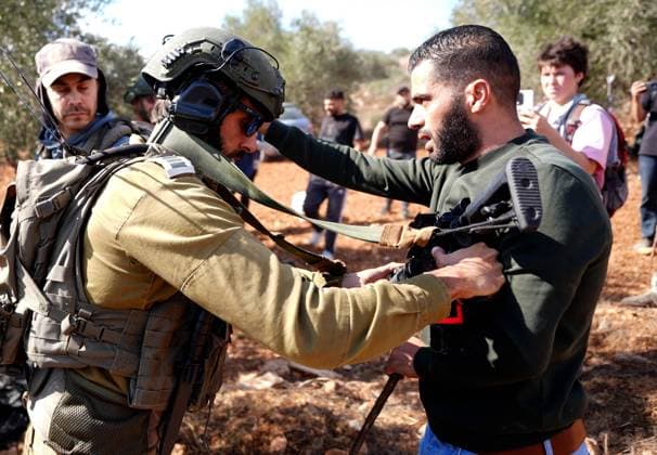 Israeli forces injure Palestinian farmer during raids on olive farms NABLUS, WEST BANK, PALESTINE - OCTOBER 2: Israeli military forces and settlers intervene against Palestinian farmers and international activists harvesting olives in the town of Beita, in Nablus, West Bank, Palestine on October 02, 2026. Israeli settlers beat the 46-year-old Palestinian man in the town of Beita, according to the Palestinian Red Crescent Society. Witnesses told Anadolu that a group of Israeli settlers fired stun grenades and tear gas at farmers in the Jabal al-Arma area, forcing them to leave. Issam Rimawi Anadolu Nablus West Bank. Editorial use only. Please get in touch for any other usage. Copyright: x2026xAnadoluxIssamxRimawix