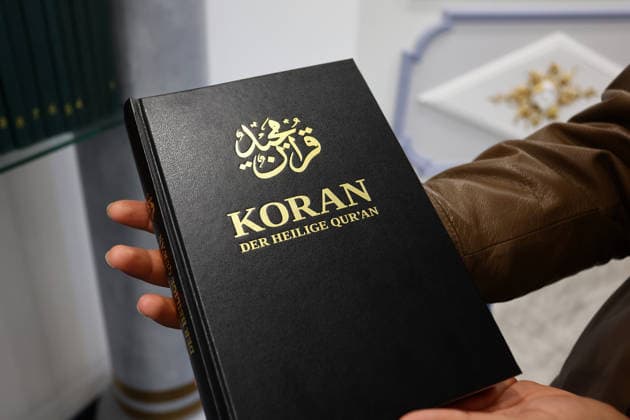 Open Mosque Day in Germany Open Mosque Day in Germany. A member shows the Quran book in the mosque Bait ur Rehman Moschee in Nuremberg, Germany . October 03rd , 2026 Photo by Davide Elias Copyright: xDavidexEliasx