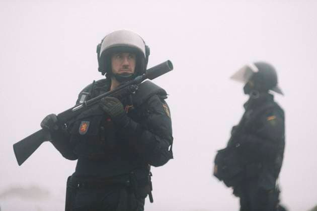 October 4, 2026, Ceuta, Ceuta, Spain: A riot police officer holds a launcher during the eviction of the makeshift migrant camp on El Trampolin beach in Ceuta. Spanish National Police began evicting the makeshift camp on El Trampolin beach in Ceuta on October 4, where more than 3,000 migrants, most of them young Moroccan men, were living. Dozens of police vans, armoured vehicles of the Police Intervention Units (UIP), drones and boats took part in the operation. People were taken by bus to the temporary centre at the Tarajal border to be identified, and the authorities plan to clear the beach in phases before October 15. The camp grew after a mass arrival at the end of July 2026 set off a migration and political crisis. Ceuta Spain - ZUMAs392 20261004_zip_s392_003 Copyright: xFabianxSuspensivox