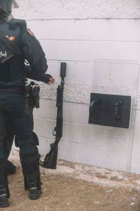 October 4, 2026, Ceuta, Ceuta, Spain: A riot police officer leans a launcher against a wall during the eviction of the makeshift migrant camp on El Trampolin beach in Ceuta. Spanish National Police began evicting the makeshift camp on El Trampolin beach in Ceuta on October 4, where more than 3,000 migrants, most of them young Moroccan men, were living. Dozens of police vans, armoured vehicles of the Police Intervention Units (UIP), drones and boats took part in the operation. People were taken by bus to the temporary centre at the Tarajal border to be identified, and the authorities plan to clear the beach in phases before October 15. The camp grew after a mass arrival at the end of July 2026 set off a migration and political crisis. Ceuta - ZUMAs392 20261004_zip_s392_027 Copyright: xFabianxSuspensivox
