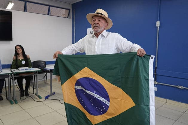 (261004) -- BRASILIA, Oct. 4, 2026 -- Brazilian President Luiz Inacio Lula da Silva, presidential candidate of Brazil s ruling Workers Party, displays a national flag of Brazil after casting his ballot at a polling station in Sao Bernardo do Campo, Brazil, Oct. 4, 2026. Voting in the first round of Brazil s 2026 presidential election officially began at 8 a.m. (1100 GMT) on Sunday, with polling stations across the country scheduled to close at 5 p.m. (0800 GMT). Initial results are expected to be announced within a few hours after the polls close. (Photo by Xinhua) BRAZIL-PRESIDENTIAL ELECTION-VOTING PauloxLopes