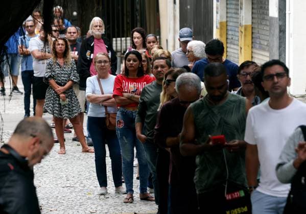 October 4, 2026, Rio De Janeiro, Rio De Janeiro, Brazil: Voters wait in line outside Escola Municipal MaroÂ­lia de Dirceu, a polling place in Brazil on Election Day as millions of citizens head to the polls in the countryÃ¢â‚¬â ¢s closely contested 2026 general election. The presidential race between incumbent Luiz InoÂ¡cio Lula da Silva and right-wing Senator FloÂ¡vio Bolsonaro has dominated the campaign, with polls showing a tight contest ahead of the October 4 first round. Brazilians are also voting for governors, senators and federal and state legislators. Rio De Janeiro Brazil - ZUMAk251 20261004_znp_k251_001 Copyright: xBobxKarpx