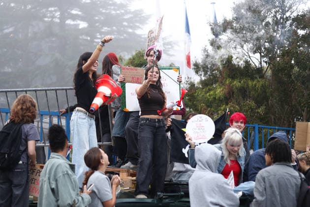 October 5, 2026, Bayonne, Nouvelle Aquitaine, France: High school students hold placards, one reading High school students shout slogans, one holding a smoke flare, as they stand on a barricade during a protest against the government outside the Reno Cassin high school in Bayonne, southwestern France, on October 5, 2026. A placard reads We wanted the baccalaureate, they send us the BAC , a pun on the French police anti-crime brigade. Students have been blocking schools across France since September 21 to demand more teachers, smaller classes and better school buildings. Bayonne France - ZUMAb298 20261005_zsp_b298_010 Copyright: xJulesxBuonx