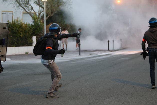 October 5, 2026, Anglet, Nouvelle Aquitaine, France: A plainclothes police officer from the anti-crime brigade (BAC) throws a tear gas canister towards youths during a protest by high school students against the government outside the Cantau high school in Anglet, southwestern France, on October 5, 2026. Students have been blocking schools across France since September 21 to demand more teachers, smaller classes and better school buildings. Cantau was closed by authorities after clashes in recent days. Anglet France - ZUMAb298 20261005_zsp_b298_004 Copyright: xJulesxBuonx