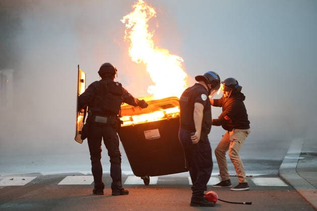 October 5, 2026, Anglet, Nouvelle Aquitaine, France: French police officers push a burning waste container during a protest by high school students against the government outside the Cantau high school in Anglet, southwestern France. Students have been blocking schools across France to demand more teachers, smaller classes and better school buildings. Cantau was closed by authorities after clashes in recent days. Anglet France - ZUMAb298 20261005_zsp_b298_018 Copyright: xJulesxBuonx