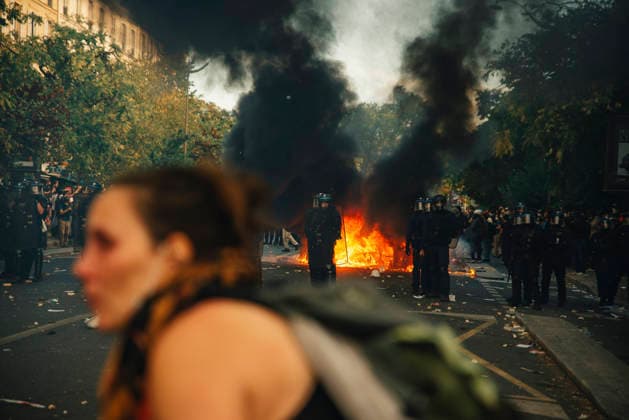 Paris Students Protest Education Conditions A demonstrator passes in the foreground as flames and black smoke rise behind her in Paris, France, on October 6, 2026. France s Interior Ministry said 256,000 people marched nationwide, including 56,000 in Paris, during the student-led day of action over school conditions. High school students called for more education funding and staff, smaller classes and improved facilities, with teachers, parents and unions joining demonstrations. Paris Ile de France France Copyright: xDavoodxMaeilix