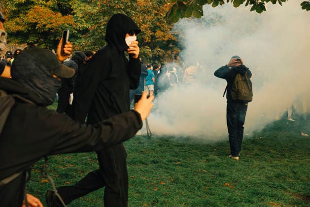 Paris Students Protest Education Conditions A masked demonstrator runs across grass as journalists and other protesters look on in Paris, France, on October 6, 2026. France s Interior Ministry said 256,000 people marched nationwide, including 56,000 in Paris, during the student-led day of action over school conditions. High school students called for more education funding and staff, smaller classes and improved facilities, with teachers, parents and unions joining demonstrations. Paris Ile de France France Copyright: xDavoodxMaeilix