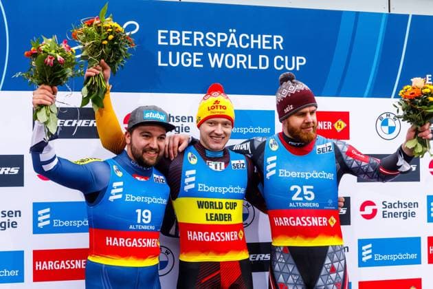 Luge World Cup Altenberg 2024 DEU Germany Saxony Altenberg, 03 02 2024, Eberspaecher Luge World Cup in Altenberg, SachsenEnergie Eiskanal, Doubles Men, Flower Ceremony, Podium Winner Max Langenhan GER, center , David Gleirscher AUT, left, 2nd place and Kristers Aparjods LAT, right, 3rd place AF_Altenberg_Rodel_44108