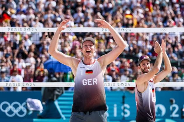 FRA, Paris, Olympic Games Paris 2024, 03 08 2024, Beach Volleyball Mens Round of 16, Eiffel Tower Centre Court Nils Ehlers Germany, 1 and Clemens Wickler Germany, 2 against George Souto Maior Wanderley Brazil, 1 and Andre Loyola Stein Brazil, 2 Clemens Wickler Germany, 2 and Nils Ehlers Germany, 1 celebrate after the victory Copyright: HMBxMedia SteffiexWunderl