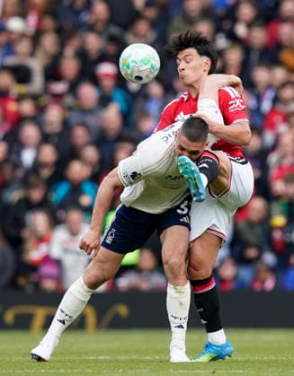 Manchester, England, 17th May 2026. Lisandro Martinez of Manchester United, ManU tackles Nikola Milenkovic of Nottingham Forest during the Manchester United vs Nottingham Forest Premier League match at Old Trafford, Manchester. Picture credit should read: Andrew Yates Sportimage EDITORIAL USE ONLY. No use with unauthorised audio, video, data, fixture lists, club league logos or live services. Online in-match use limited to 120 images, no video emulation. No use in betting, games or single club league player publications. SPI_113_AY_Man_Utd_Forest SPI-4806-0104