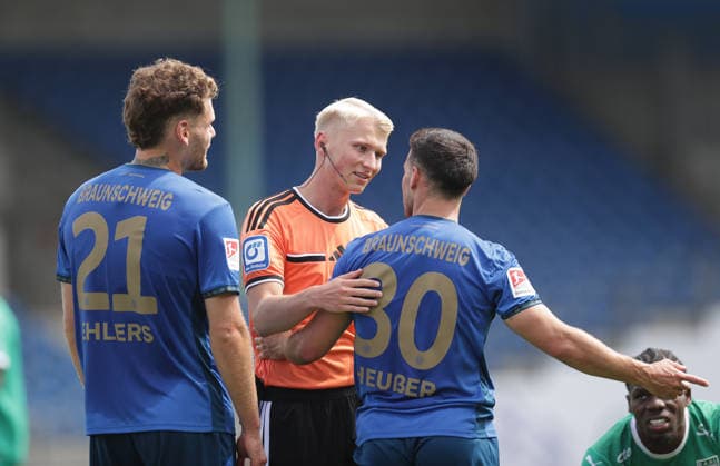 Referee Luca Sambill, Kevin Ehlers (Eintracht Braunschweig), Robin Heusser (Eintracht Braunschweig), Soccer, Men s, 2026–2027 Season, 2nd Bundesliga, Eintracht Stadium, Eintracht Braunschweig vs. RAAL La Louvière, preseason, friendly match, 0–0. DFL regulations prohibit any use of photographs as image sequences and or quasi-video.