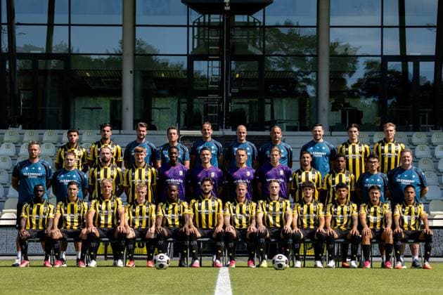 ARNHEM , 04-08-2026 , Nationaal Sportcentrum Papendal , season 2026 2027 , Dutch Keuken Kampioen Divisie football , Photocall , picture shows Vitesse squad with, back row L-R, Vitesse player Ayman Sellouf, Vitesse player Omar Achouitar, Vitesse performance coach Lars Smeenk, Vitesse assistant coach Timm Fahrion, Vitesse head coach Rudiger Rehm, Vitesse assistant coach Mike van Dijk, Vitesse goalkeeper coach Rein Baart, Vitesse physiotherapist Tijmen Gores, Vitesse player Koen te Veluwe, Vitesse player Eduard Probst, middle row L-R, Vitesse team manager Erwin Mulder, Vitesse kit manager Fabian van Drumpt, Vitesse player Valon Zumberi, Vitesse player Marcus Steffen, Vitesse goalkeeper Tyrick Bodak, Vitesse goalkeeper Connor van den Berg, Vitesse goalkeeper Maximilian Brull, Vitesse goalkeeper Jayden Siecker, Vitesse player Naoufal Bannis, Vitesse player Nathan Markelo, Vitesse video analyst Yuhao Zhang, Vitesse kit manager Leon Keijman, front row L-R, Vitesse player Solomon Bonnah, Vitesse player Youssef Ouallil, Vitesse player Chiel Olde Keizer, Vitesse player Mathijs Marschalk, Vitesse player Joao Pinto, Vitesse player Marco Schikora, Vitesse player Alexander Buttner, Vitesse player Nino Zonneveld, Vitesse player Yuval Ranon, Vitesse player Ricardo Schwarz, Vitesse player Filipe de Carvalho and Vitesse player Xiamaro Thenu pose for a teamphoto Photocall Vitesse x205454198x Copyright: