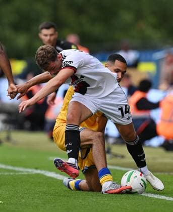 Harrison Burrows of Sheffield United is tackled by Jon Russell of Mansfield Town Mansfield Town v Sheffield United, EFL Carabao Cup, First Round, Football, One Call Stadium, Mansfield, UK - 09 Aug 2026Mansfield One Call Stadium United Kingdom EDITORIAL USE ONLY No use with unauthorised audio, video, data, fixture lists, club league logos or live services. Online in-match use limited to 120 images, no video emulation. No use in betting, games or single club league player publications. Copyright: xAnnaxGowthorpe Shutterstockx 17051191ck