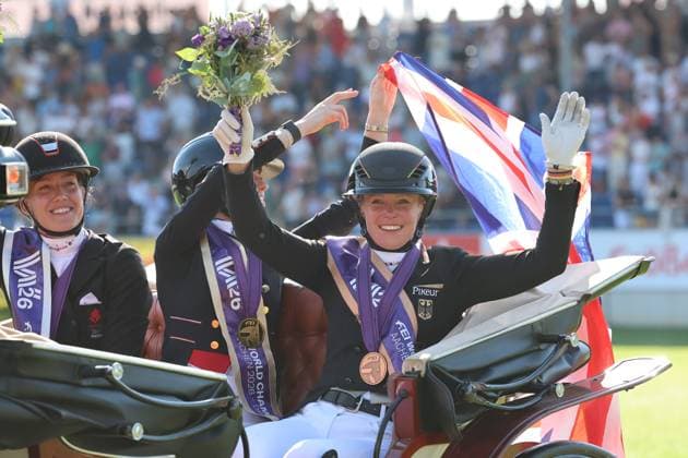 Lap of honor after the award ceremony, with Katharina Hemmer (GER, Germany) waving and celebrating on the outside of the carriage; 1st place: Charlotte Fry (GBR, Great Britain, United Kingdom) on Glamourdale; 2nd place: Cathrine Laudrup Dufour (DEN), Denmark, on Mount St John Freestyle; 3rd place, bronze: Katharina Hemmer (GER), Germany, Denoix PCH, Dressage, FEI Dressage World Championship MEGGLE Prize, Grand Prix Special, Individual Classification, AACHEN FEI World Championships 2026, World Festival of Equestrian Sports, 2026 Equestrian World Championships, Aachen 2026, Welcome Home 2026, Aachen Soers, August 11–23, 2026, Equestrian Sports, August 14, 2026, Aachen Soers, Germany