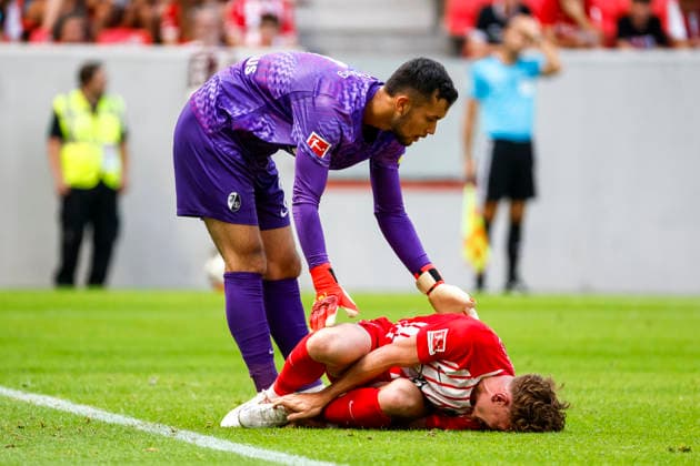Philipp Treu (SC Freiburg), 29, injured on the ground, with Mio Backhaus (SC Freiburg), 01, Germany, soccer, friendly match, 2026–2027, SC Freiburg vs. Crystal Palace, August 15, 2026, Freiburg im Breisgau, Europa-Park Stadium, Germany Copyright: xGrantxHubbsx