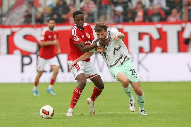 September 20, 2026, xtgx, Soccer, 2. Bundesliga, FC Energie Cottbus vs. FC St. Pauli, from left: King Manu (Cottbus), 2, Connor Metcalfe (St. Pauli), 24: Tackle, duel, battle, DFL and DFB regulations prohibit any use of photographs as image sequences and or quasi-video. Cottbus