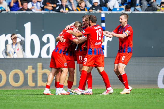 September 20, 2026 Soccer, 2026–2027, 2. Bundesliga, Matchday 6, DSC Arminia Bielefeld 1, FC Heidenheim 2. L: Paul Hennrich (Heidenheim) celebrates his goal to make it 1–2, surrounded by a group of teammates, including (L–R) Alessandro Vogt (Heidenheim) and Budu Zivzivadze (Heidenheim), Jan Schöppner (Heidenheim), and Patrick Mainka (Heidenheim). DFL regulations prohibit any use of photographs as image sequences and or quasi-video.