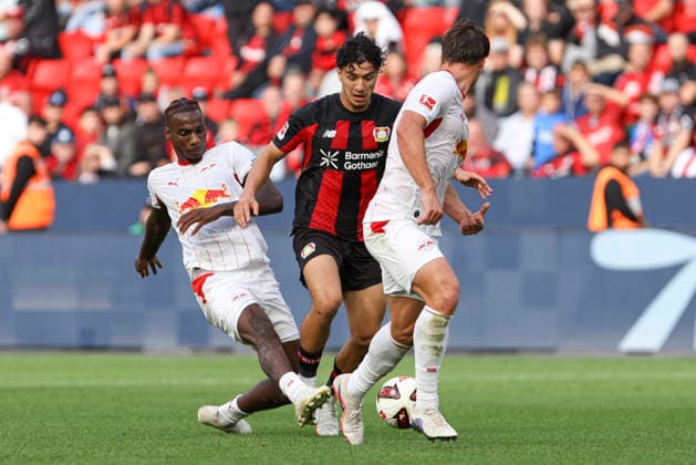 Ezechiel Banzuzi (RB Leipzig), Ibrahim Maza (Bayer 04 Leverkusen), and Willi Orban (RB Leipzig) in a tackle during the Bundesliga 1 match between Bayer 04 Leverkusen and RB Leipzig, BayArena on September 20, 2026, in Leverkusen, Germany. Photo by Oliver Kaelke, DeFodi Images. Ezechiel Banzuzi (RB Leipzig), Ibrahim Maza of Bayer 04 Leverkusen, and Willi Orban of RB Leipzig battle for the ball during the Bundesliga match between Bayer 04 Leverkusen and RB Leipzig at BayArena on September 20, 2026 in Leverkusen, Germany. Photo by Oliver Kaelke, DeFodi Images. DFB and DFL regulations prohibit any use of photographs as image sequences and or quasi-video. Photo by Oliver Kaelke, DeFodi Images.